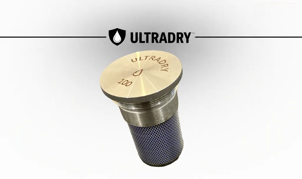An premium stainless steel ULTRADRY drying cartridge with an engraved stainless steel top cap and an 8mm mesh body containing reusable blue silica desiccant, shown against a white background with the ULTRADRY brand logo at the top.
