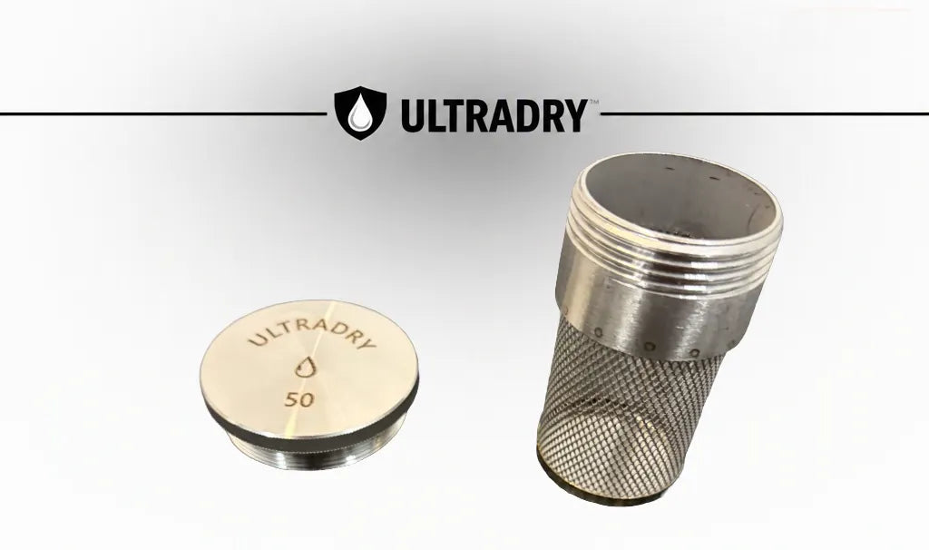 ULTRADRY stainless steel mesh desiccant component shown in two pieces on a light gray background, with the ULTRADRY logo at the top. One piece is a round stainless steel cap with 'ULTRADRY 50' laser engraved on it, and the other is a threaded metal body with a fine mesh screen.