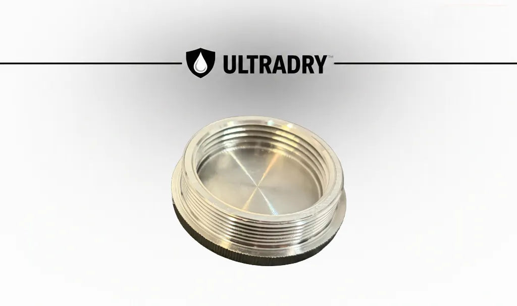 A ULTRADRY branded stainless steel threaded cap used to seal desiccants in use shown on a white background with a ULTRADRY logo banner at the top.