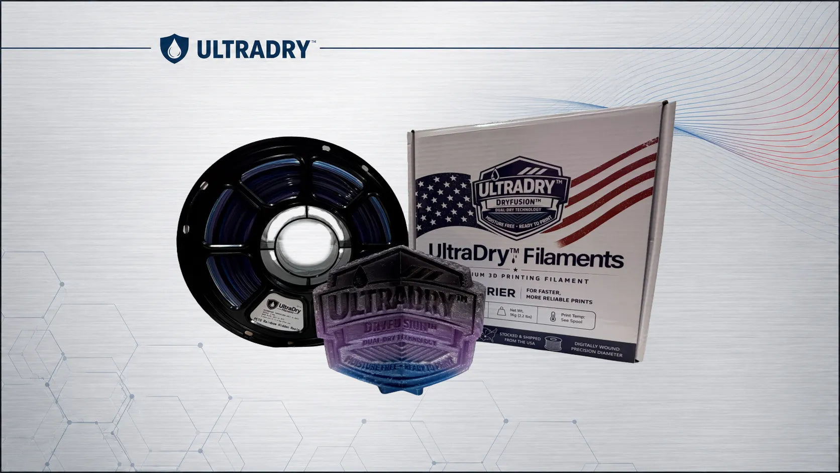 ULTRADRY filament product display showing a spool of premium UlraDry Rainbow Hidden Realm Purple, blue, and black filament with the product box and a 3D Printed sculpture made from the high end filament on a light gray patterned background with the ULTRADRY logo.