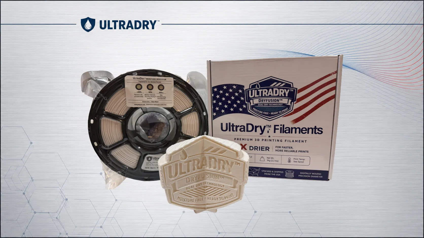 ULTRADRY filament spool and branded box on a light gray graphic background. The spool contains off-white filament, with a matching ULTRADRY box and a small hexagonal ULTRADRY label in front.