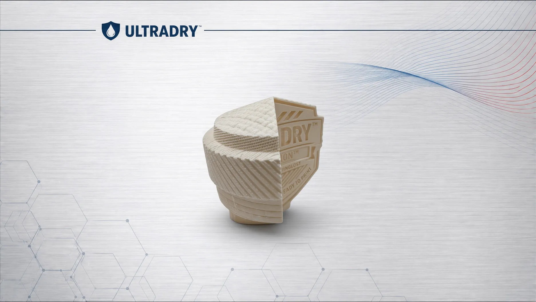 A 3D-printed cylindrical component with a textured surface and a triangular section showing the word 'DRY', floating on a light gray background with the ULTRADRY logo at the top left.